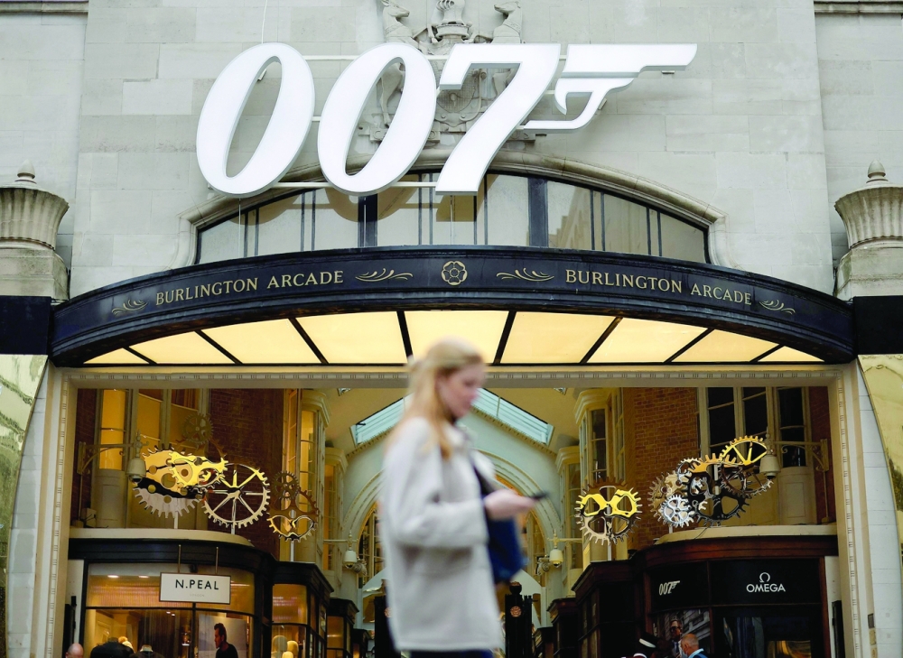 A pedestrian walks past a James Bond 007 logo above the entrance to Burlington Arcade in London. AFP file photo