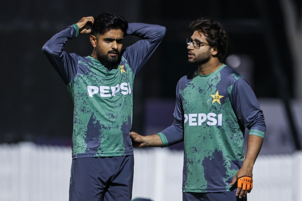 Pakistan's Imam-ul-Haq (R) speaks with teammate Babar Azam during a practice session at the ICC Academy ground in Dubai 