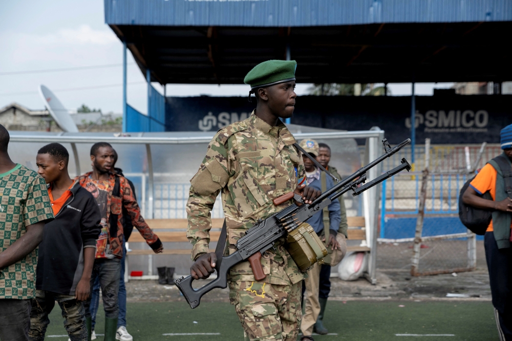 A M23 rebel supervises Congolese soldiers who surrendered in Bukavu. — Reuters 