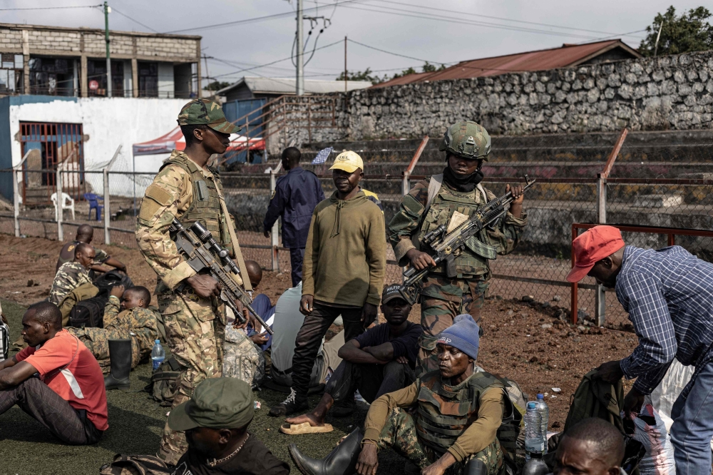 Members of the M23 movement stand guard