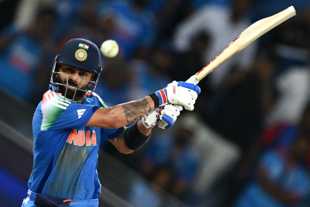 India's Virat Kohli hits the winning boundary and completes his century (100 runs) during the ICC Champions Trophy one-day international (ODI) cricket match between Pakistan and India at the Dubai International Stadium in Dubai on February 23, 2025.  (Photo by Jewel SAMAD / AFP)

