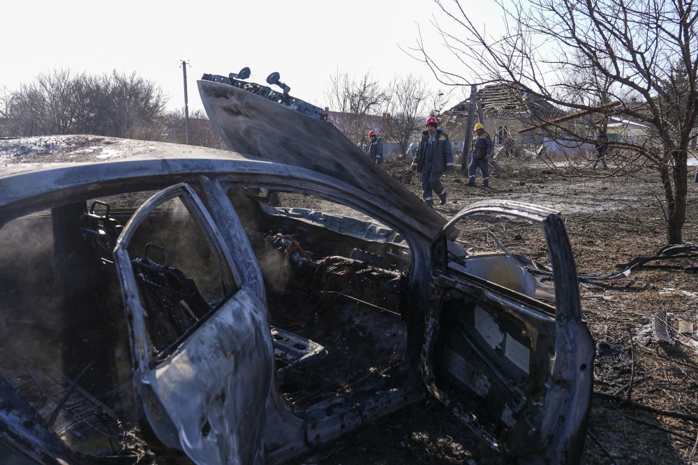 Municipal workers operate next to a car destroyed by a Russian airstrike, amid Russia’s attack on Ukraine, in Kramatorsk, Donetsk region, Ukraine. - Reuters
