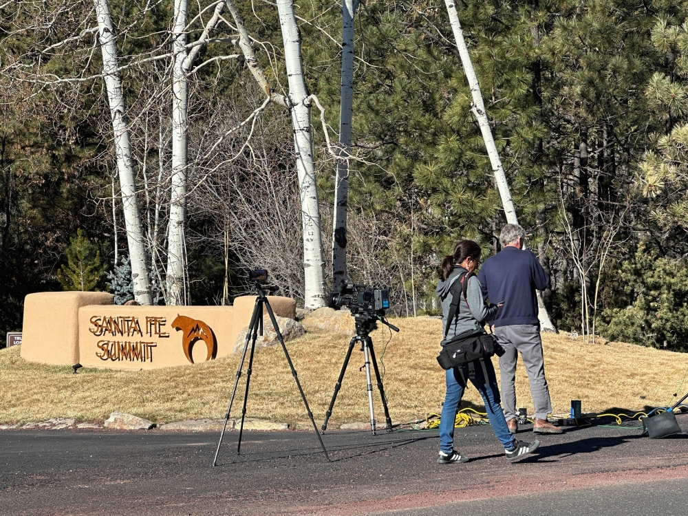 Reporters gather outside the entrance to the gated community where actor Gene Hackman was found dead on Wednesday with his wife and dog, in Santa Fe, New Mexico, U.S., February 27, 2025. REUTERS/Andrew Hay