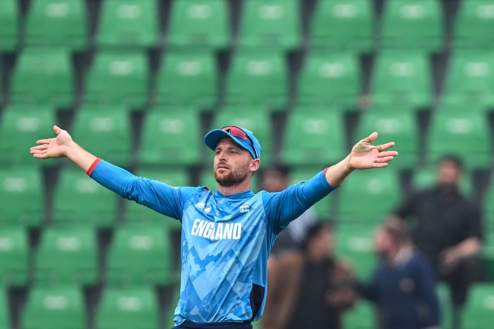 England's captain Jos Buttler adjusts the field during the ICC Champions Trophy one-day international (ODI) cricket match between England and Afghanistan at the Gaddafi Stadium in Lahore on February 26, 2025.  (Photo by Aamir QURESHI / AFP)