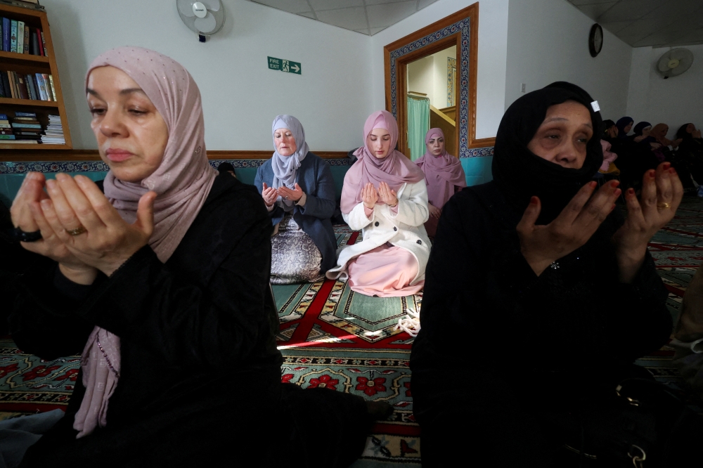 Worshippers attend prayers at London Islamic Cultural Society mosque in London. - Reuters 