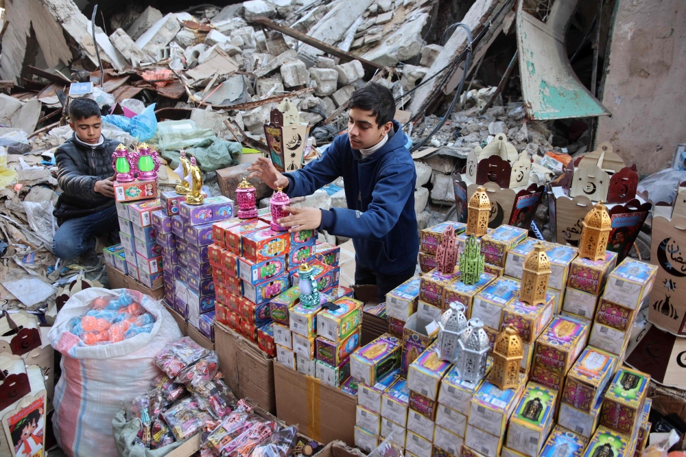 Palestinian youths sell Ramadan lanterns at the old Zawiya market in Gaza City. — AFP 