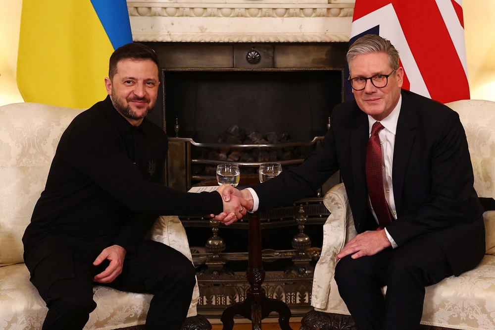 Britain's Prime Minister Keir Starmer shakes hands with Ukraine's President Volodymyr Zelensky during a bilateral meeting in central London
