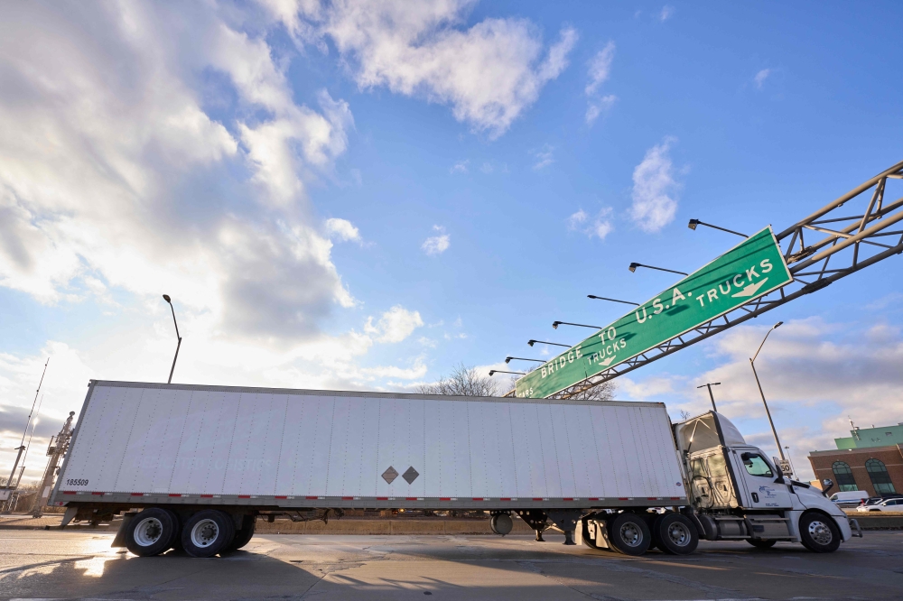 A truck takes the exit to the Ambassador Bridge border crossing in Windsor, Ontario, Canada, 