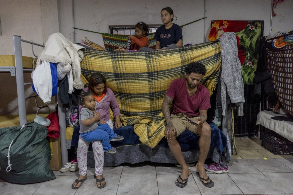 Jordan García, bottom right, a former mining worker from Venezuela, with his wife and their three daughters at Albergue Vida, a migrants shelter in Ciudad Juárez, March 1, 2025. (Alejandro Cegarra/The New York Times)