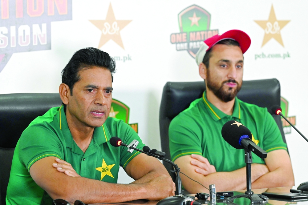 Pakistan head coach Aaqib Javed (L) and captain Salman Agha address a press conference at the Gaddafi Stadium in Lahore on Tuesday, ahead of their first Twenty20 international match against New Zealand. — AFP