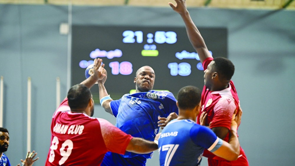 Ahli Sidab make a scoring attempt as Oman Club players defend.