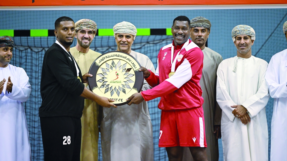 The Oman Club captain receives the league shield.