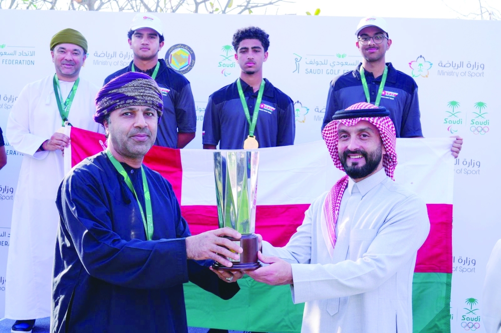 The team receives trophy from Noah Alireza, CEO Golf Saudi