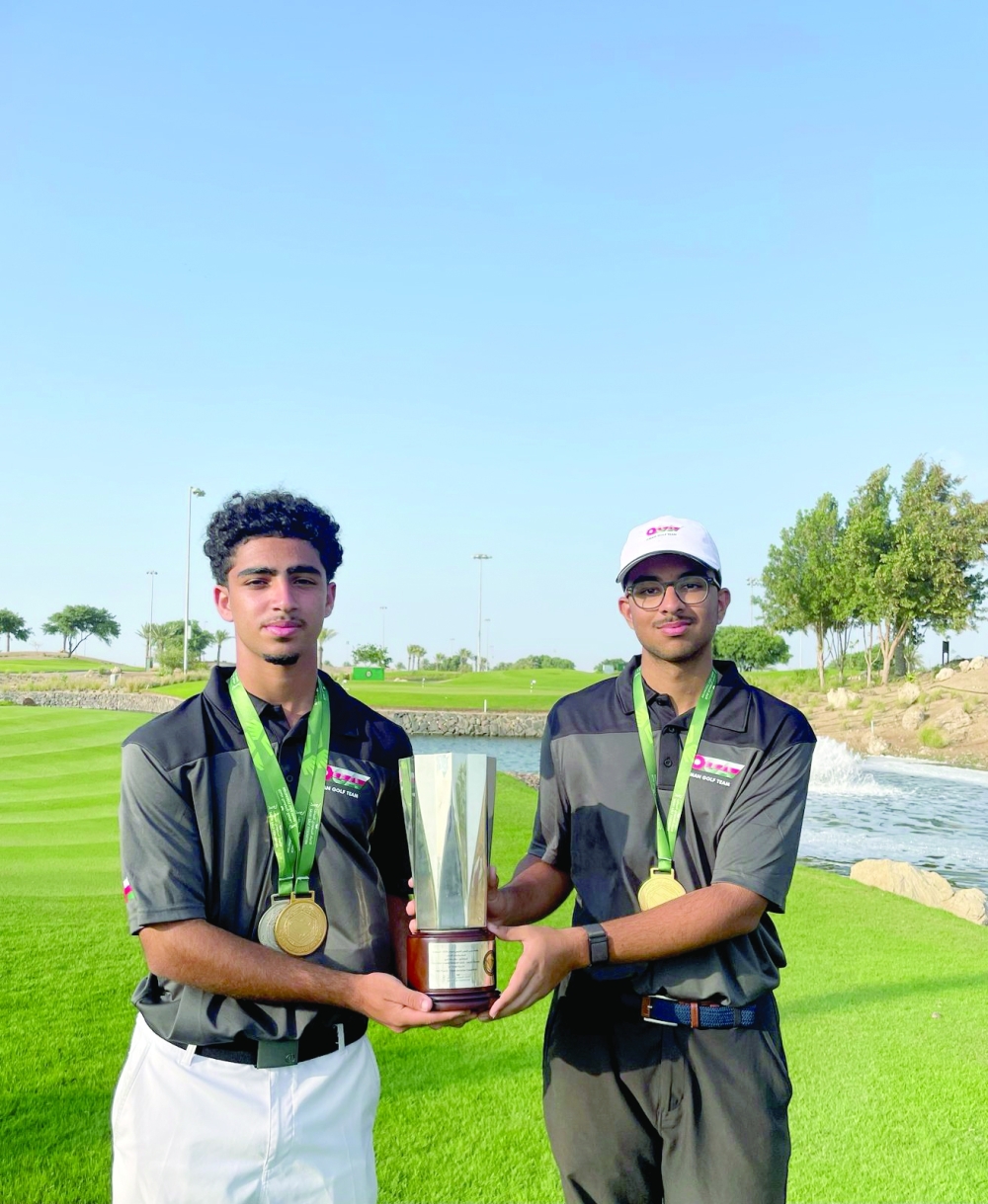Adam and Mahir Sampat hold the trophy at the Royal Greens Golf & Country Club in Jeddah
