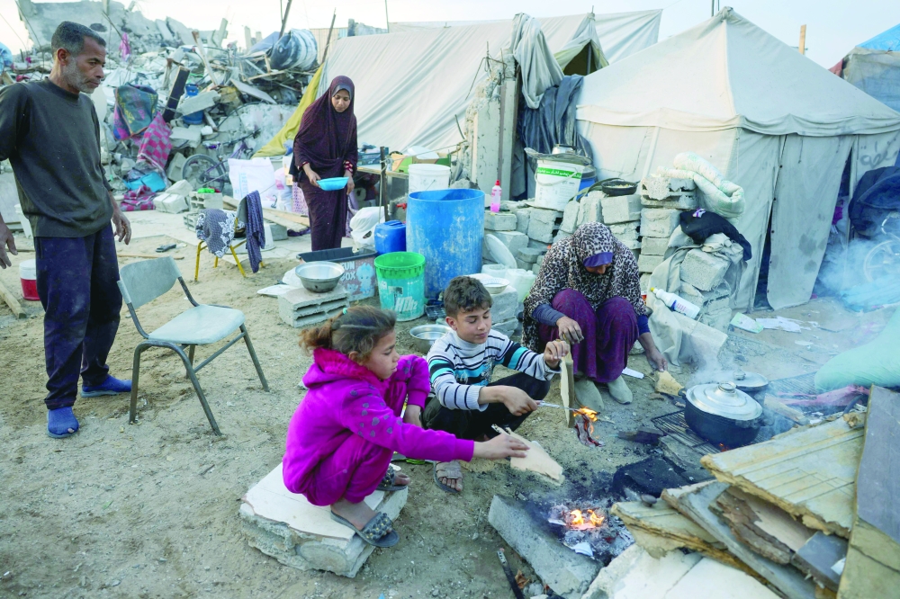 Palestinian family prepare a fast-breaking iftar meal outside