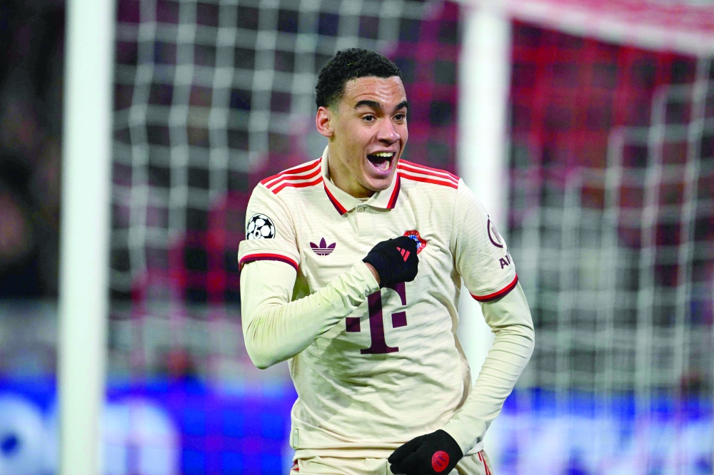 Bayern Munich's German midfielder #42 Jamal Musiala celebrates scoring the 2-0 goal during the Uefa Champions League last 16, first-leg, football match FC Bayern Munich v Bayer 04 Leverkusen on March 5, 2025 in Munich, southern Germany.  (Photo by Tobias SCHWARZ / AFP)