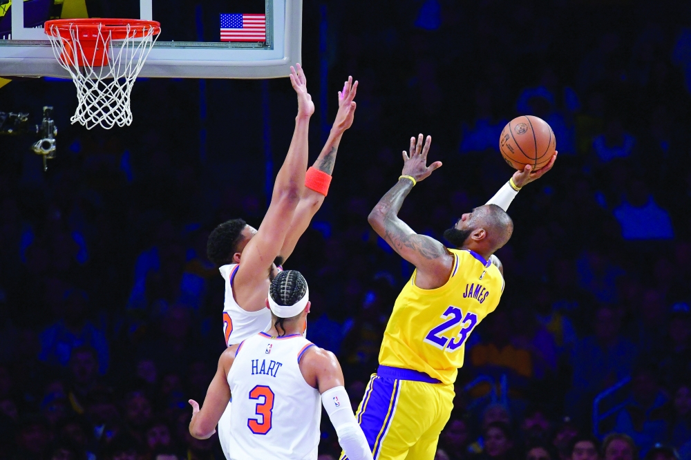 Los Angeles Lakers forward LeBron James (23) shoots against New York Knicks center Karl-Anthony Towns (32) during the first half at Crypto.com Arena.