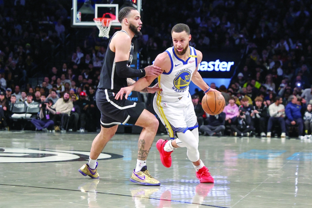 Golden State Warriors guard Stephen Curry (30) drives past Brooklyn Nets guard Tyrese Martin (13) in the first quarter at Barclays Center.