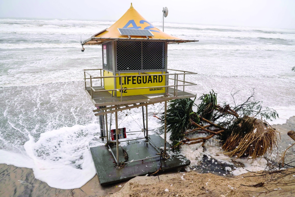 A lifeguard tower is surrounded by water on Main Beach that has been damaged by record-breaking waves caused by the outer fringe of Tropical Cyclone Alfred on the Gold Coast. — AFP