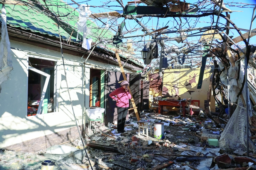 A resident stands near a house destroyed by a Russian drone strike near Odesa, Ukraine, on Friday. — Reuters