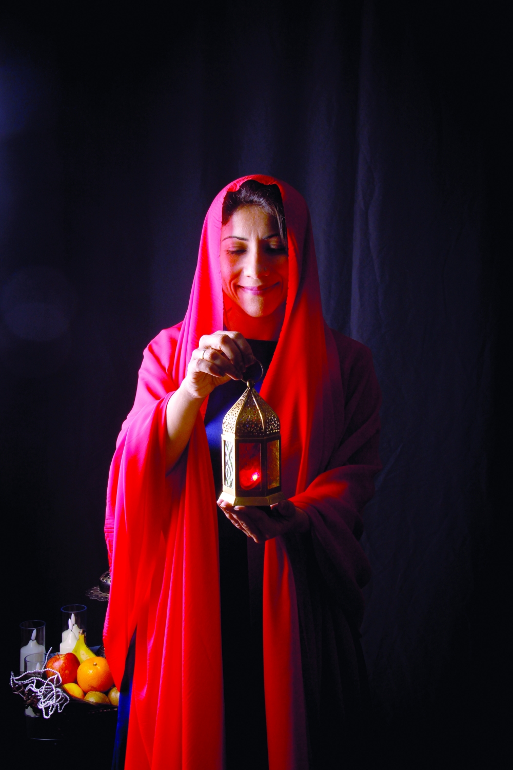 Photographer Rachel Eapen holds a glowing lantern for Suhoor