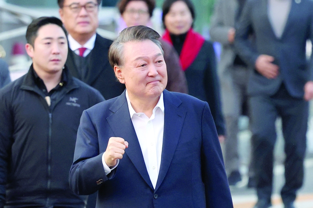 South Korean impeached President Yoon Suk Yeol gestures outside the Seoul detention centre after his release. — Reuters