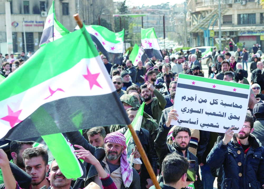 Syrians demonstrate in support of the Syrian government, in Aleppo, Syria. — Reuters