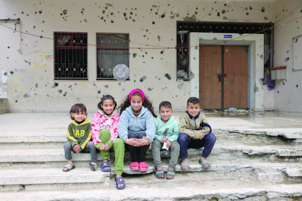 Palestinian orphans pose for a picture at the war-damaged Al Amal orphanage in Gaza City. — AFP