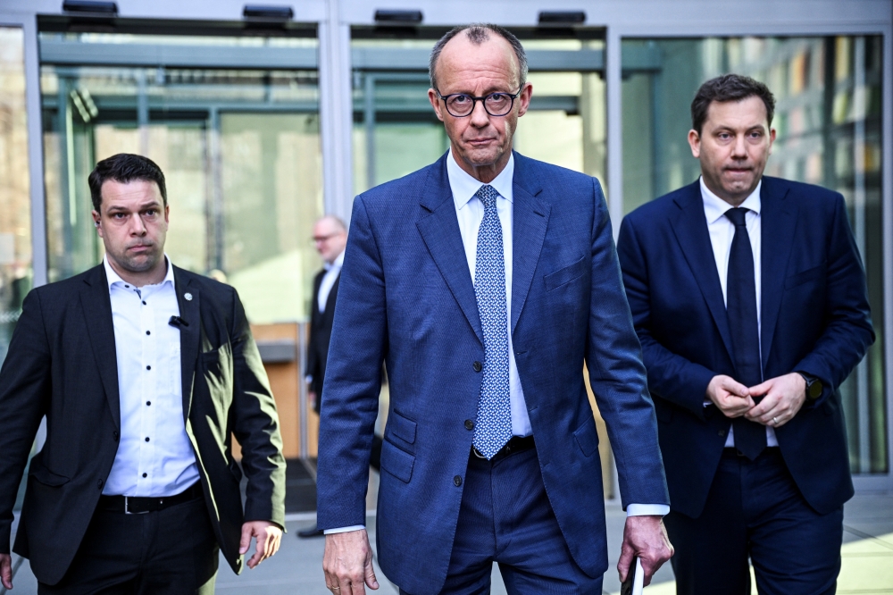 Germany's chancellor-in-waiting and leader of the Christian Democratic Union party (CDU) Friedrich Merz and co-leader of the Social Democratic party (SPD) Lars Klingbeil leave after giving a statement with Bavarian state premier and leader of the Christian Social Union (CSU) Markus Soeder and co-leader of the SPD Saskia Esken, after exploratory talks in Berlin, Germany March 8, 2025. REUTERS/Annegret Hilse