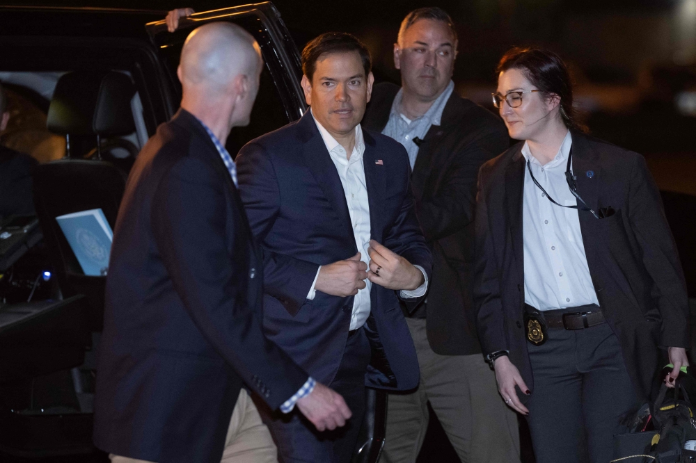 US Secretary of State Marco Rubio (C) boards a military airplane, in Homestead, Florida. — AFP 