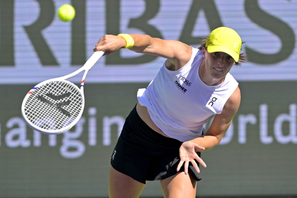 Iga Swiatek serves the ball in the third round of the BNP Paribas Open at the Indian Well Tennis Garden.— Reuters. 