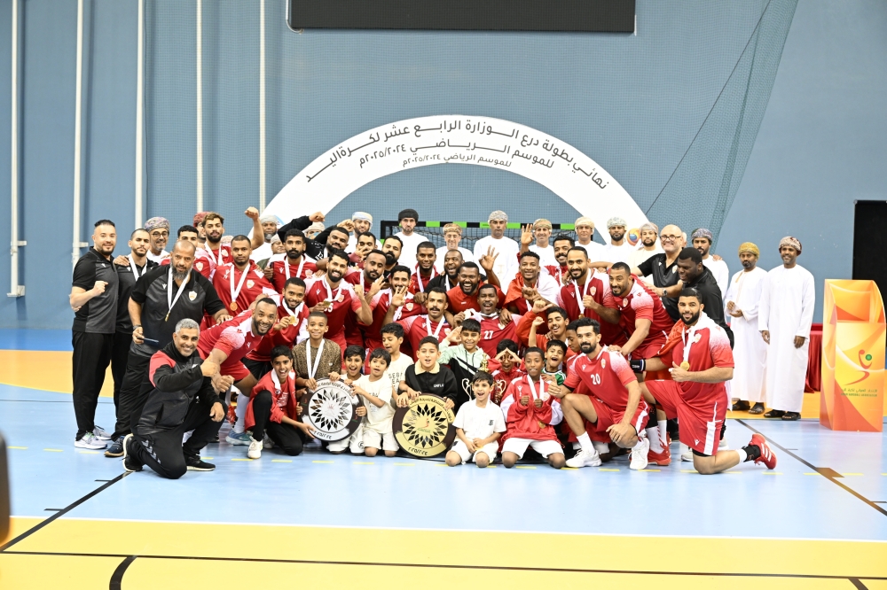 Oman Club celebrating with the trophy