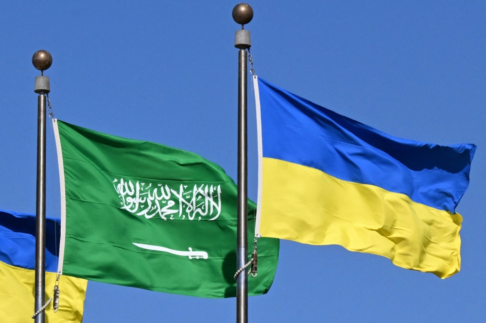 Flags of Saudi Arabia and Ukraine line the King Abdulaziz Road in the Saudi Red Sea port city of Jeddah on Monday. — AFP
