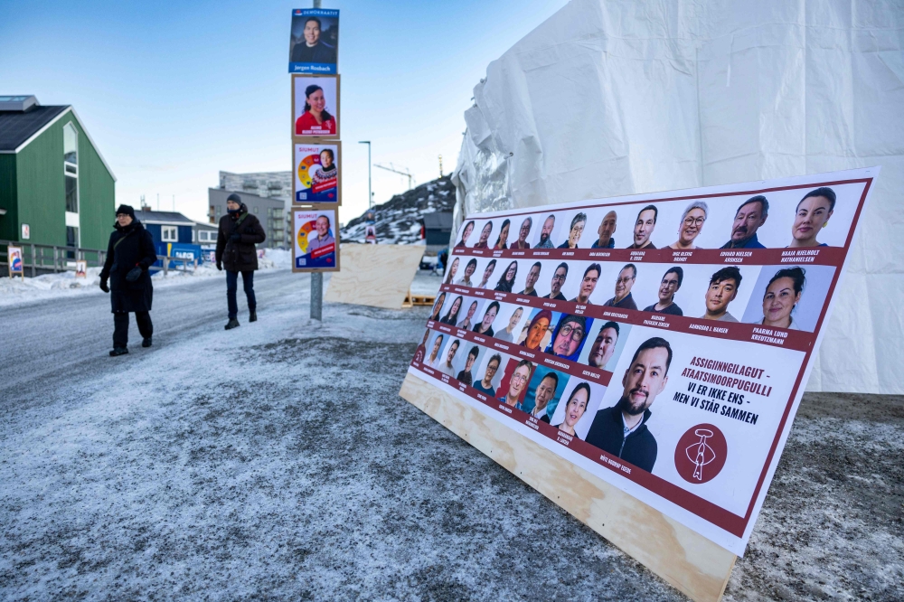 Election posters are seen outside the polling station in Nuuk, Greenland. — AFP