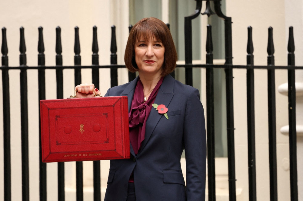 Britain's Chancellor of the Exchequer Rachel Reeves poses with the red budget box outside her office on Downing Street in London, Britain. — Reuters