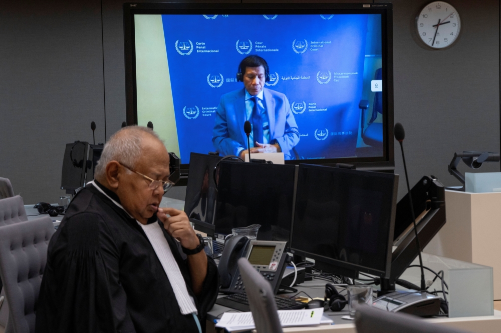 Former Philippine President Rodrigo Duterte is seen on a screen in the courtroom of the International Criminal Court (ICC) with his lawyer Salvador Medialdea in The Hague, Netherlands. - Reuters 