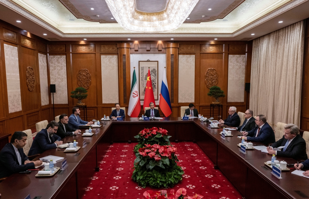 BEIJING, CHINA - MARCH 14: Chinese Foreign Minister Wag Yi, Russian Deputy Foreign Minister Sergey Ryabkov, and Iranian Deputy Foreign Minister Kazeem Gharibabadi, attend a meeting regarding the Iranian nuclear issue at Diaoyutai State Guest House on March 14, 2025 in Beijing, China.     Getty Images/Pool via REUTERS
