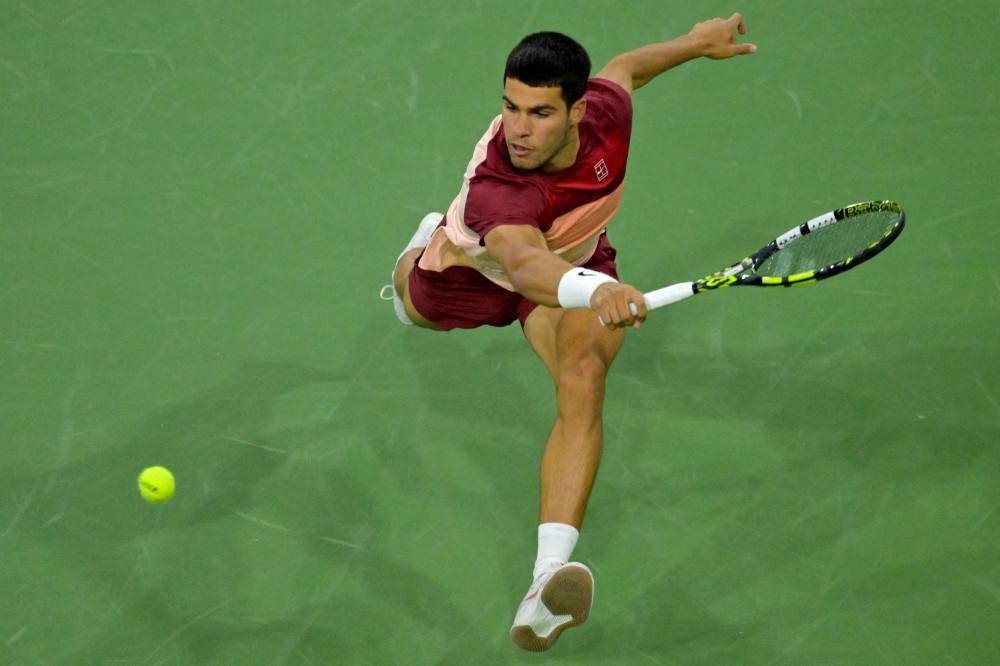 Mar 13, 2025; Indian Wells, CA, USA; Carlos Alcaraz (ESP) hits a shot as he defeated Francisco Cerundolo (not pictured) in the quarterfinal of the BNP Paribas Open at the Indian Well Tennis Garden. Mandatory Credit: Jayne Kamin-Oncea-Imagn Images

