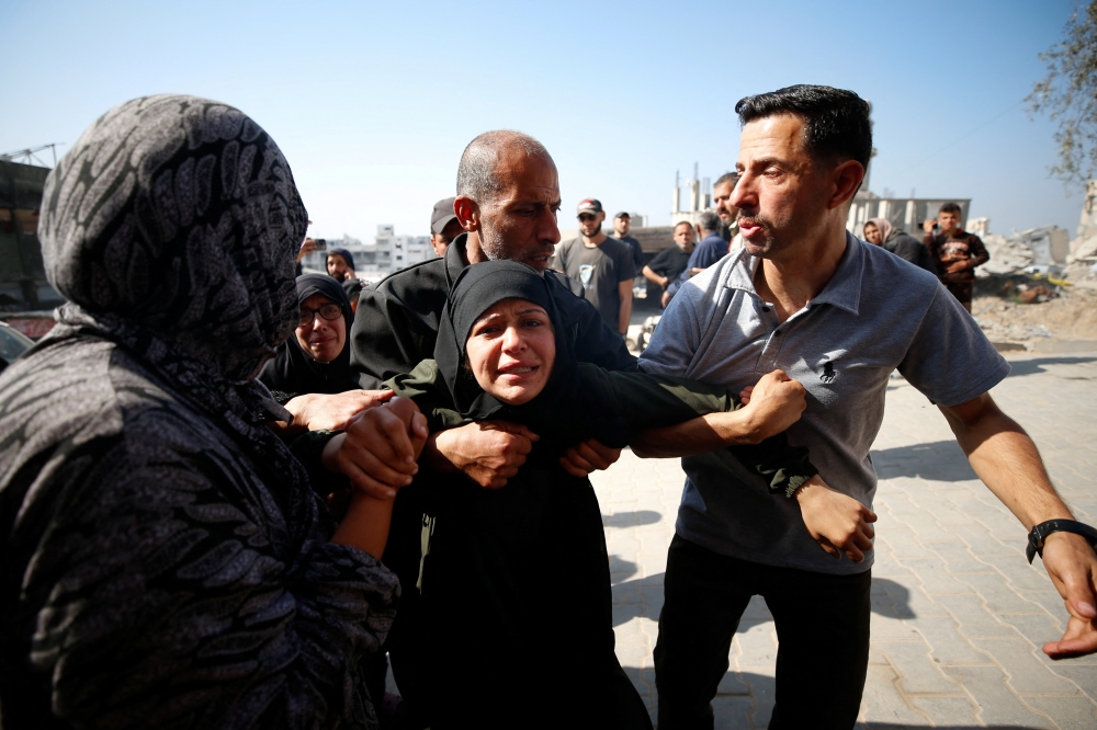 Mourners react near the bodies of Palestinians killed in an Israeli strike, in the northern Gaza Strip. — Reuters 