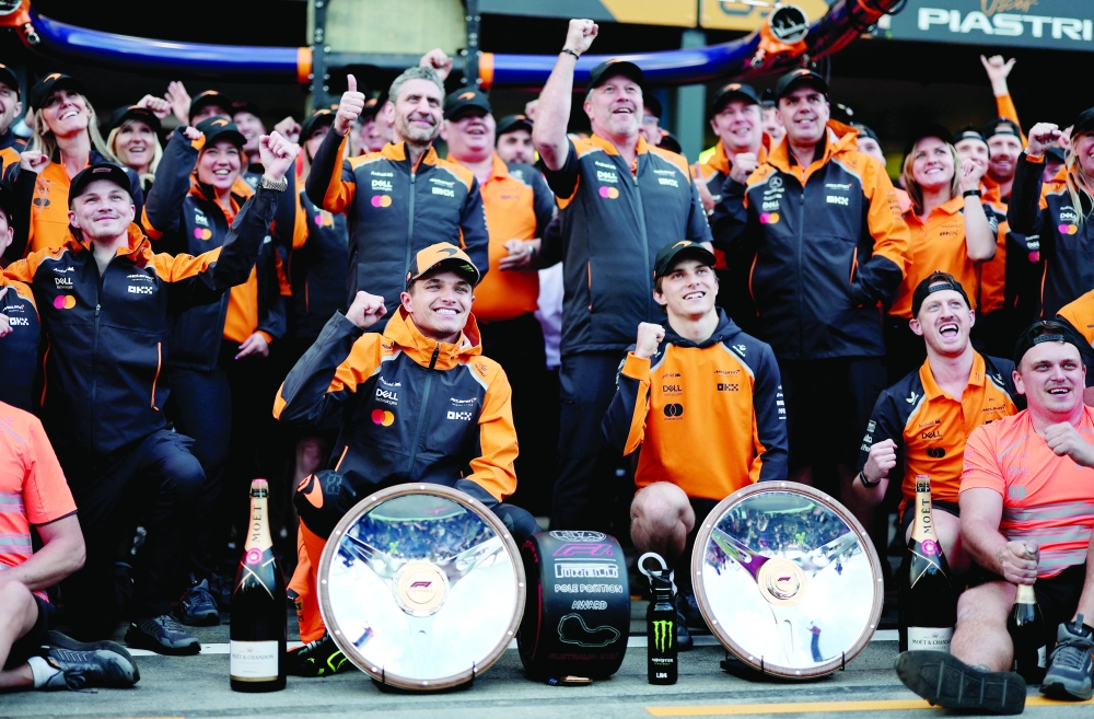 McLaren's Norris poses with trophy. — Reuters