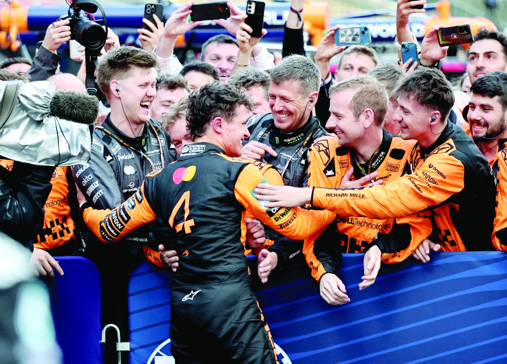 Norris celebrates with team-mates. — Reuters