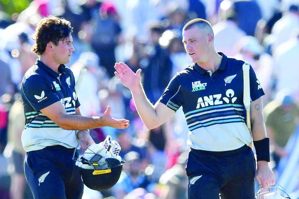 NZ's Finn (R) and Robinson celebrate their win. — AFP