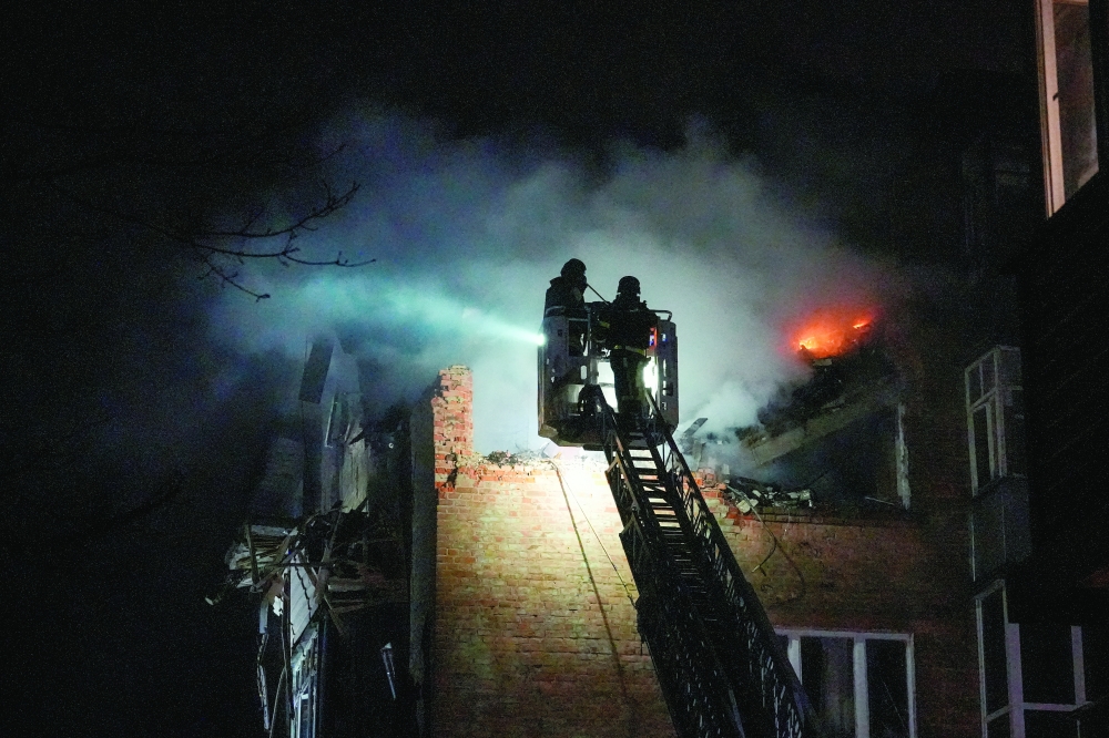 Firefighters work at the site of an apartment building hit by a Russian drone strike, in Chernihiv, Ukraine. — Reuters