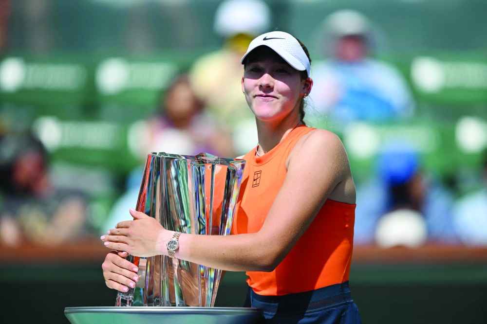 Russia's Mirra Andreeva celebrates with the trophy after defeating Belarus' Aryna Sabalenka during the women's singles final. — AFP