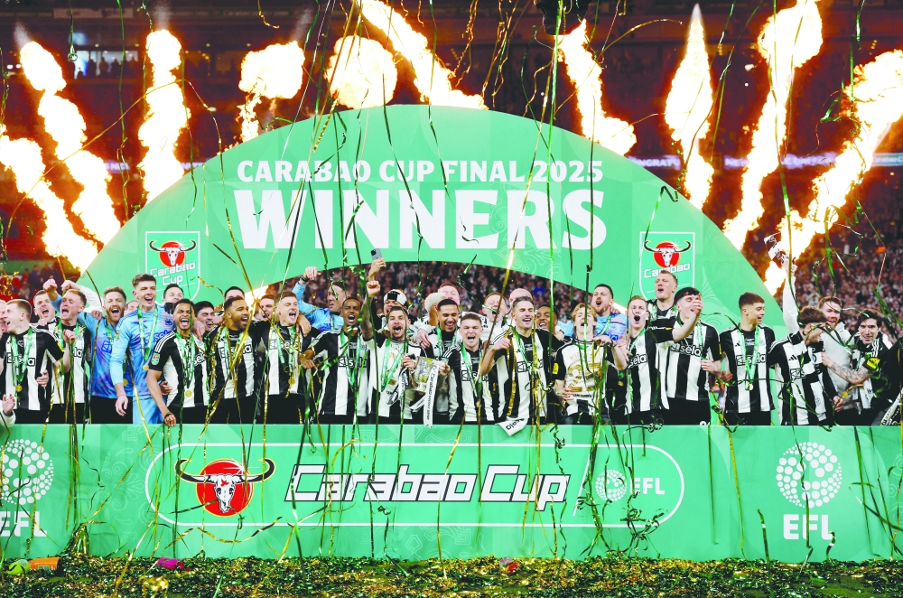 Newcastle United's players lift the trophy after winning the Carabao Cup. — Reuters