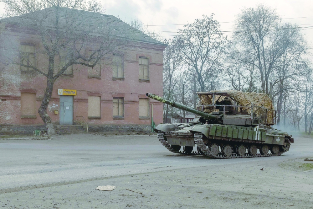 A Ukrainian tank drives on a road in a village in the Dnipropetrovsk region. — AFP