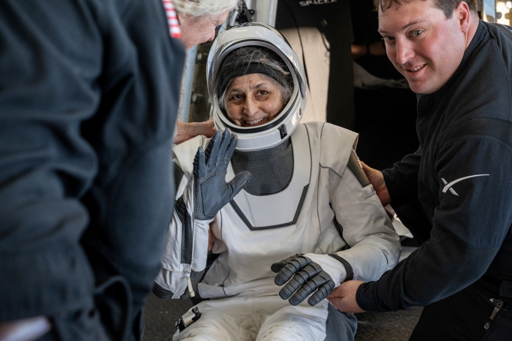 NASA astronaut Suni Williams is helped out of a SpaceX Dragon spacecraft