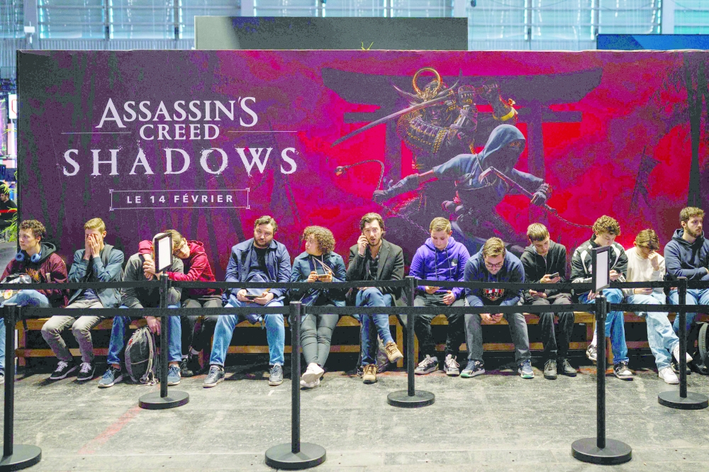 (FILES) Visitors wait in line to play the "Assassin's Creed Shadows" action role-playing video game developed by "Ubisoft Quebec" and published by Ubisoft during the Paris Games Week fair in Paris, on October 23, 2024. The worldwide release of Ubisoft's video game "Assassin's Creed Shadows" which takes place in 16th-century feudal Japan, replete with imposing fortified cities and tranquil temples crafted by developers, is set for March 20, 2025. The game is adored for painstaking historic accuracy, but also sparks controversy with heavy use of artistic license, most recently with a black samurai in the latest instalment, "Shadows". (Photo by Dimitar DILKOFF / AFP)
