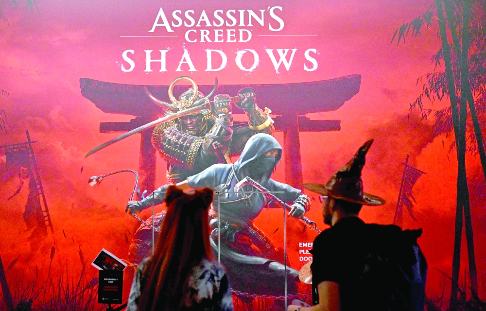 (FILES) Visitors stand at the 'Assassin's Creed Shadows' video game booth by Ubisoft during the media day at the Gamescom video games trade fair in Cologne, western Germany on August 21, 2024.  Packing familiar formulas into an all-new Japanese setting, "Assassin's Creed Shadows", the latest big-budget game from developer Ubisoft, is released worldwide on March 20, 2025. (Photo by Ina FASSBENDER / AFP)