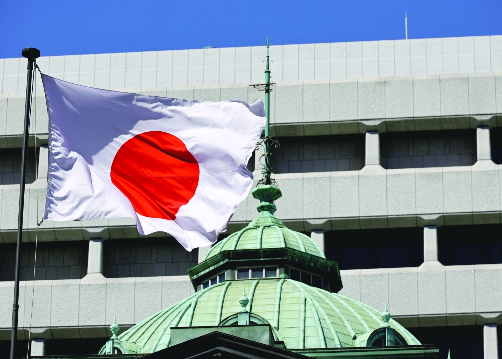 The Japanese national flag waves at the Bank of Japan building in Tokyo. — Reuters